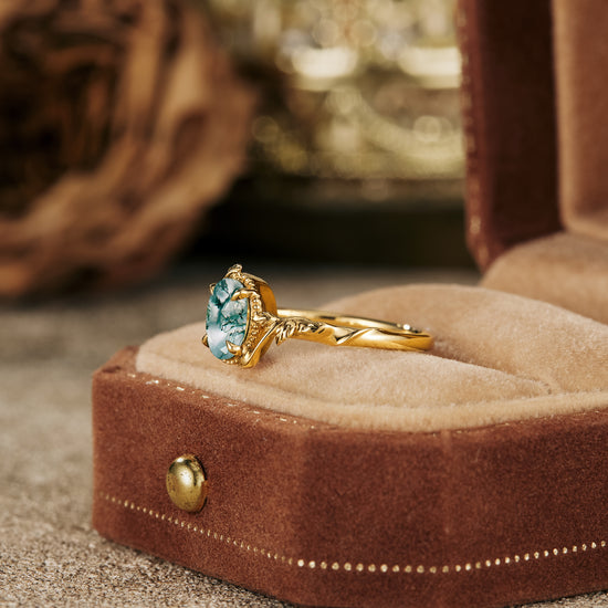 Elegant moss agate engagement ring in gold leaf setting displayed in velvet box