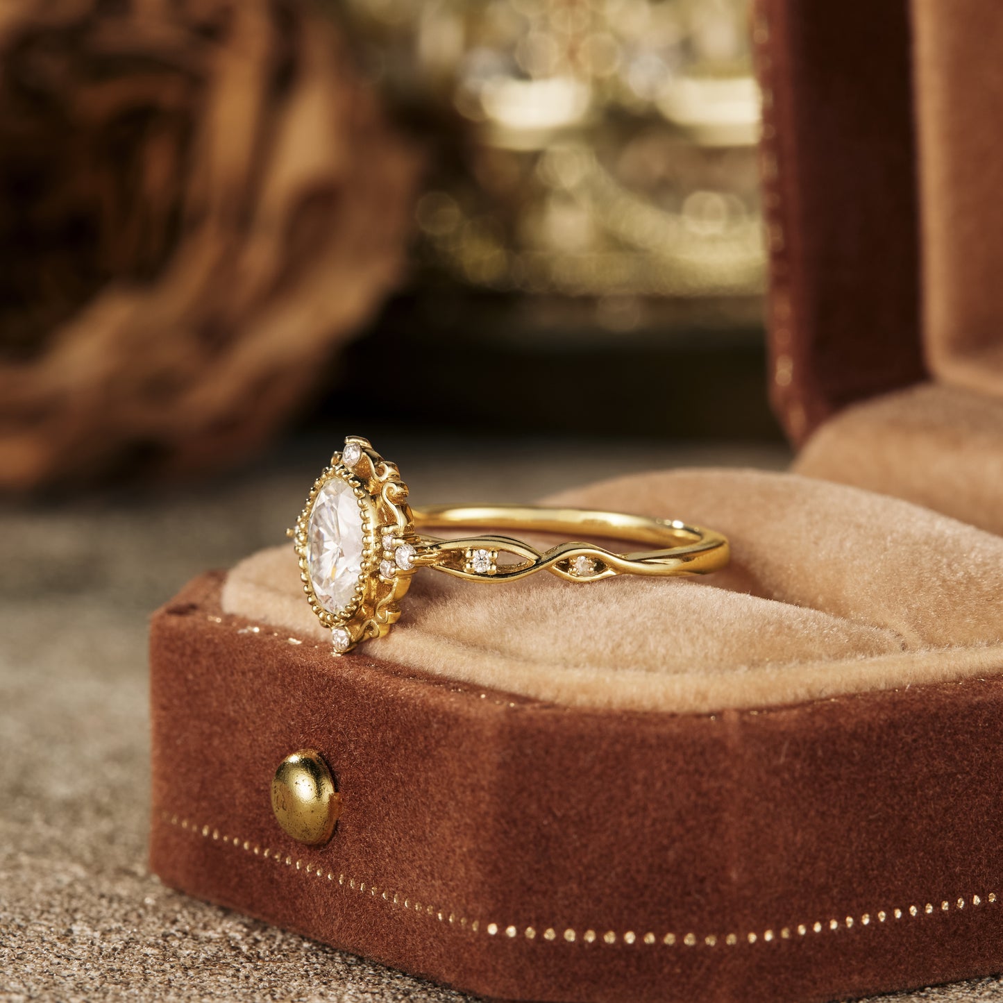 Crown-style oval moissanite engagement ring in gold with accent stones.