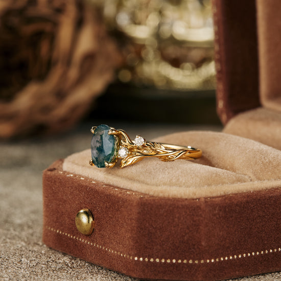 Vintage moss agate oval ring in gold leaf setting displayed in a velvet jewelry box