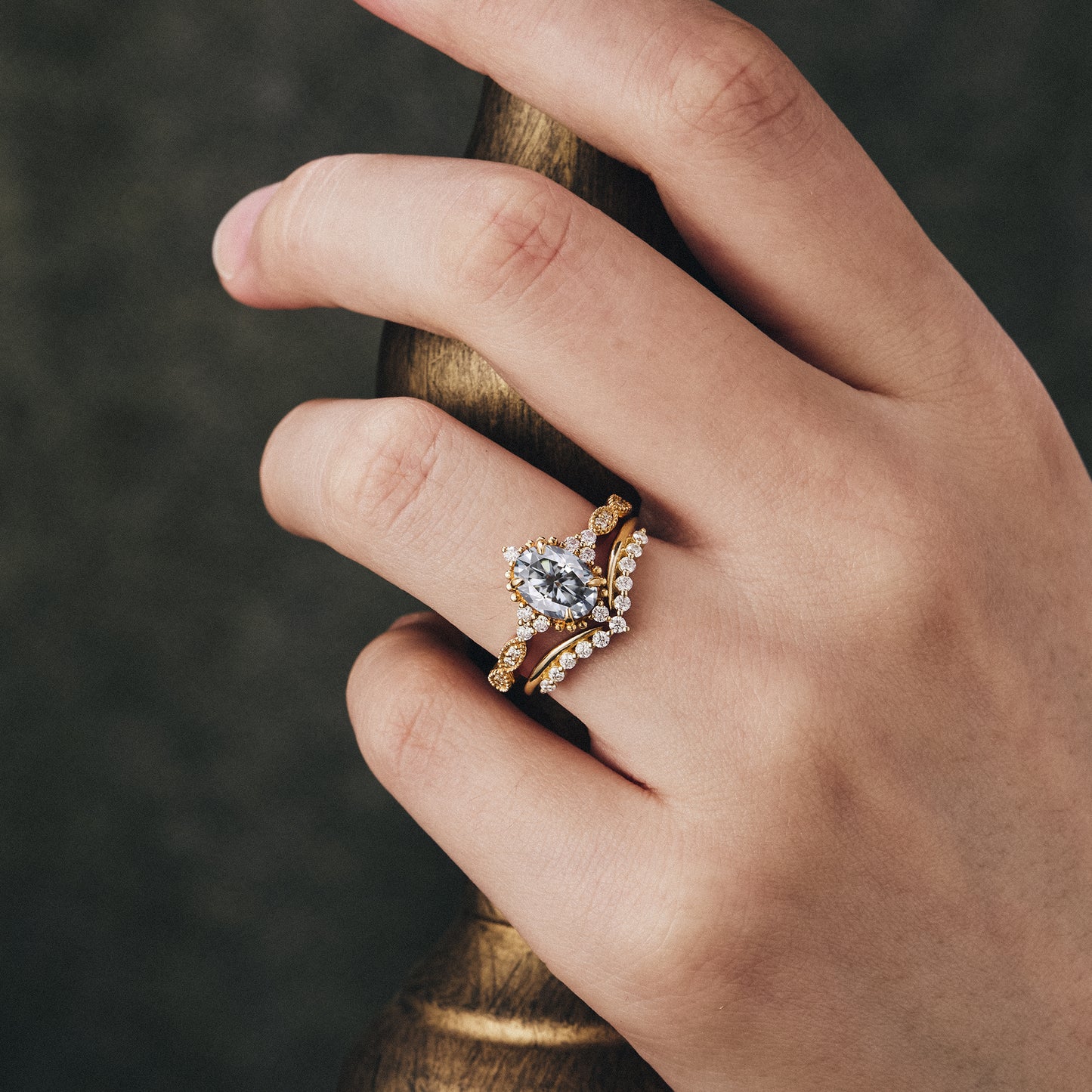 Nature-inspired gray moissanite engagement ring set on elegant display.